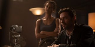 Thandiwe Newton and Hugh Jackman interview a subject in Reminiscence.