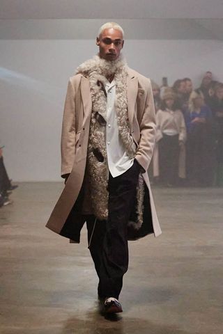 Man on Wood Wood runway with coat and furry scarf