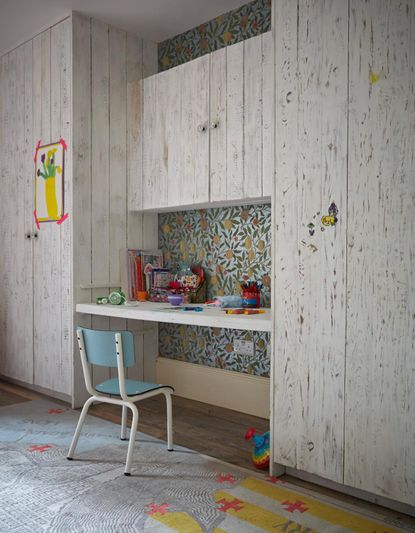 kids closet ideas with a desk built into wood clad cupboards