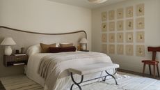 A neutral bedroom with beige walls, a large headboard with brown trim, and a gallery wall of botanics on the wall