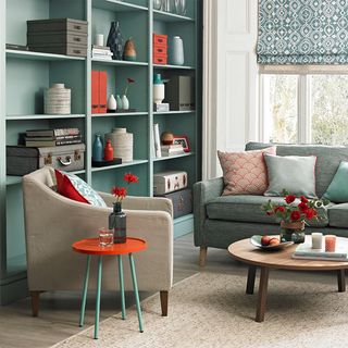 Living room shelving ideas with green painted shelves and green sofa