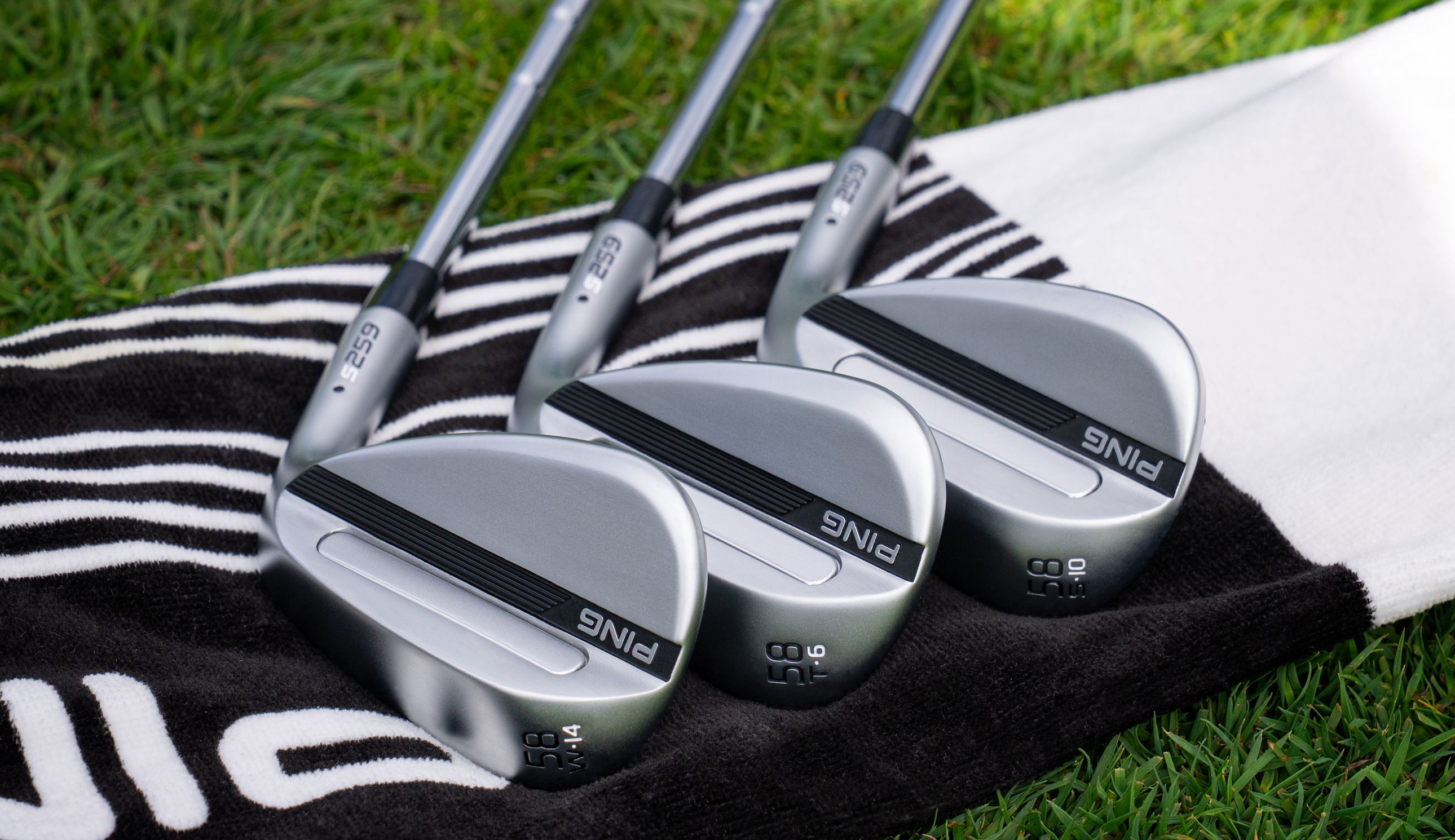 Three Ping S259 wedges lying on the ground