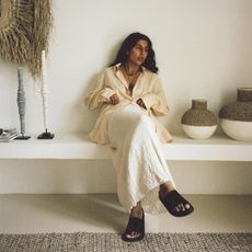 @monikh wearing a linen skirt, shirt and slides