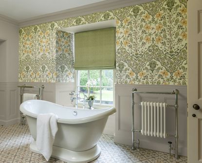 Wallpapered bathroom with green Roman blind