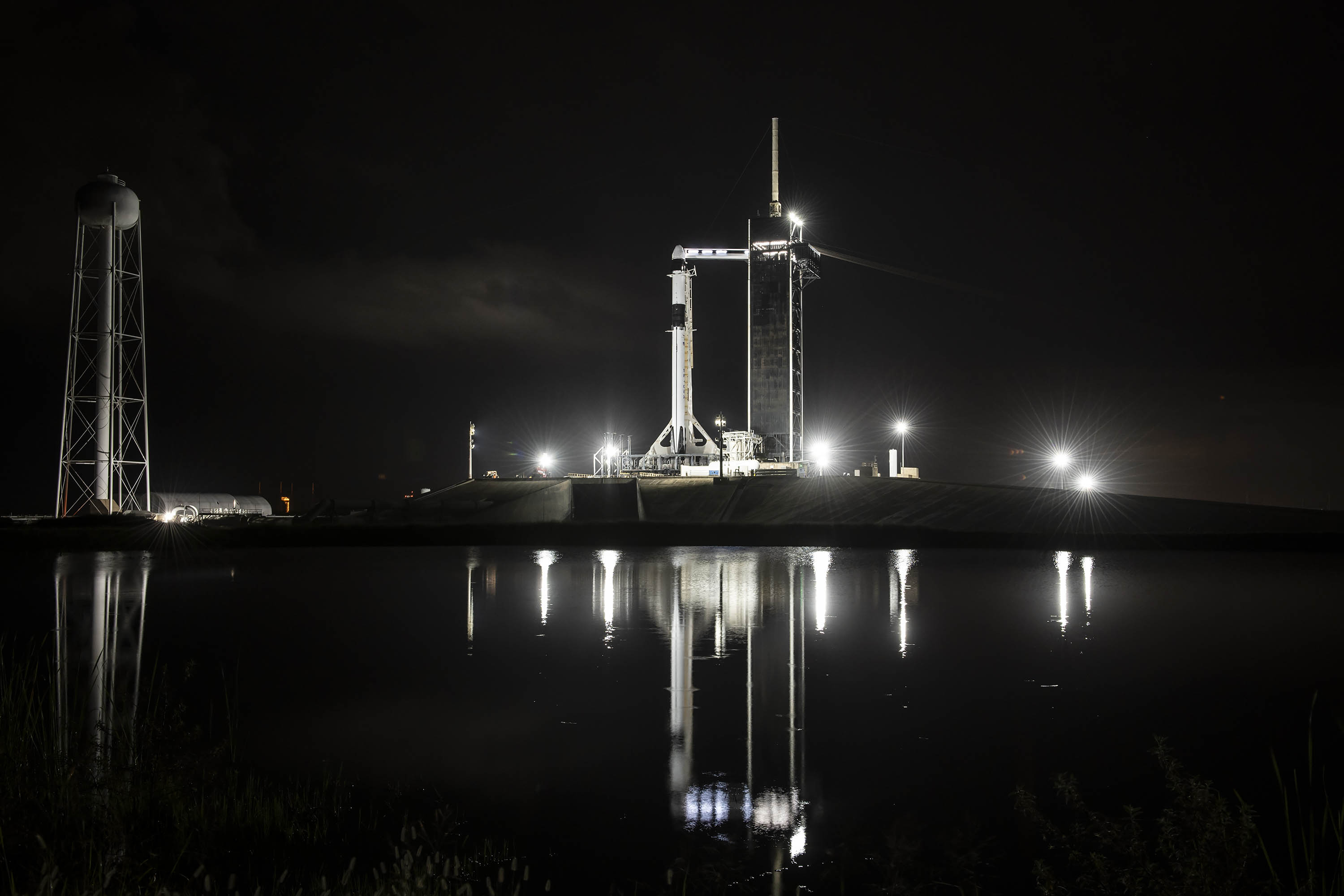 A new SpaceX Falcon 9 rocket and a previously flown Cargo Dragon spacecraft stand atop Pad 39B of NASA's Kennedy Space Center in Florida ahead of a planned Dec. 21, 2021 launch to the International Space Station.