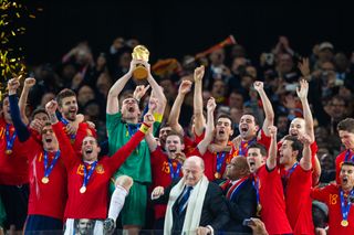 Iker Casillas lifts the World Cup trophy as Spain celebrate their win in the final against the Netherlands in July 2010.