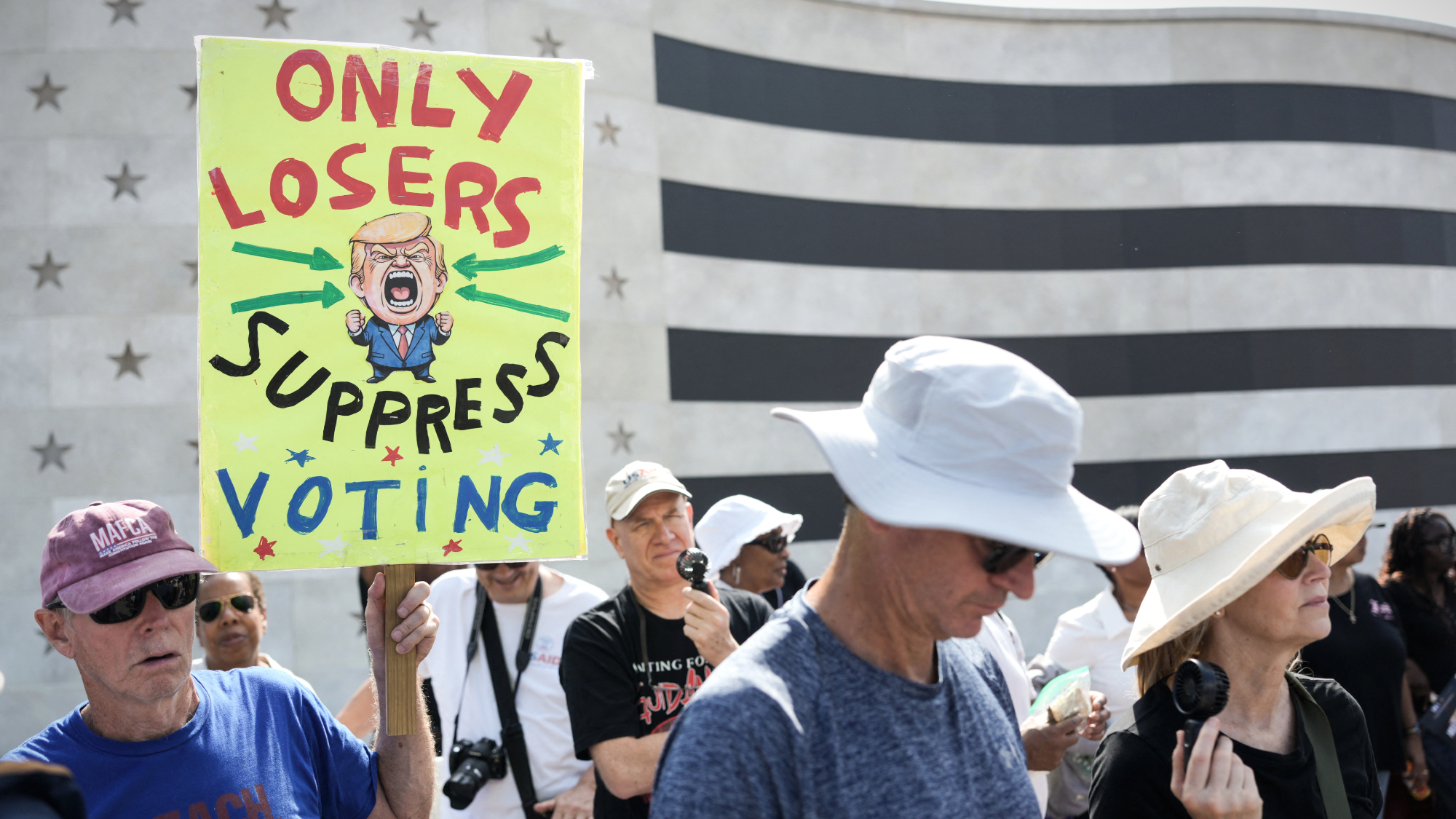 People attend a "Defend the Vote" rally near the Lincoln Memorial in Washington, D.C.