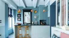 Blue apartment with island and bamboo stools