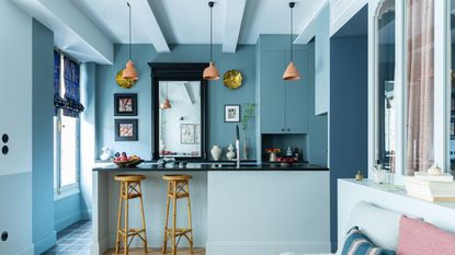 Blue apartment with island and bamboo stools