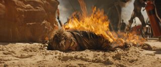 Making the VFX of The Fall Guy; a man lies in sand on fire