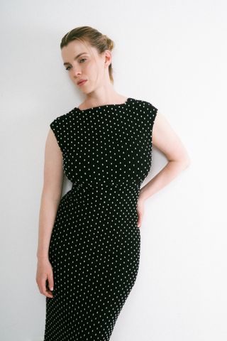 betty gilpin poses in a polka dot dress