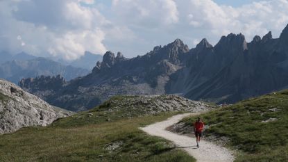 person running in the Dolomite mountains