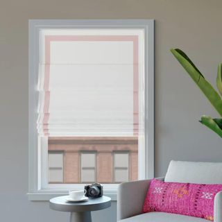 White Roman shades with a pink stripe around the border