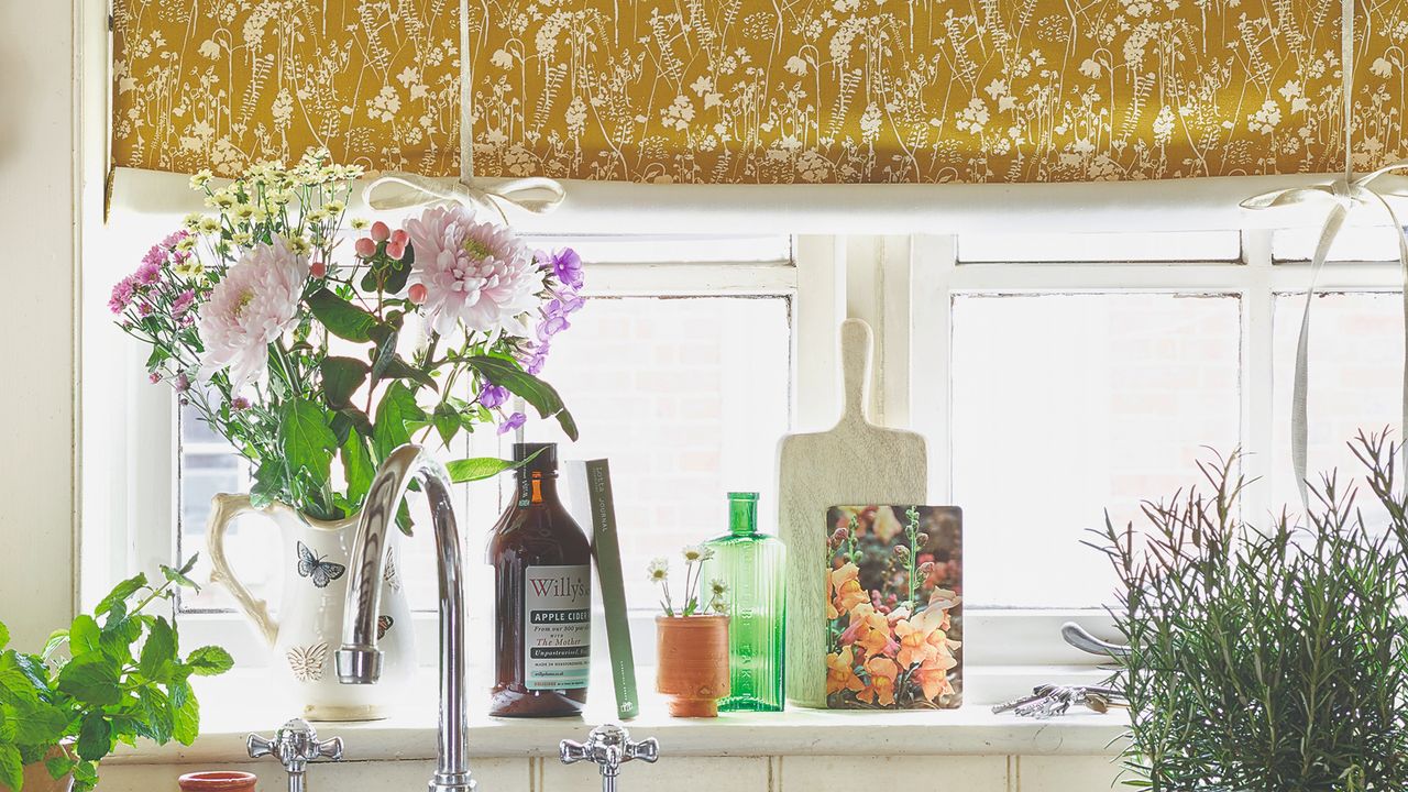 A kitchen window with a decorated windowsill