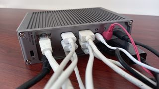 CalDigit Thunderbolt 4 dock on desk with multiple leads plugged into it