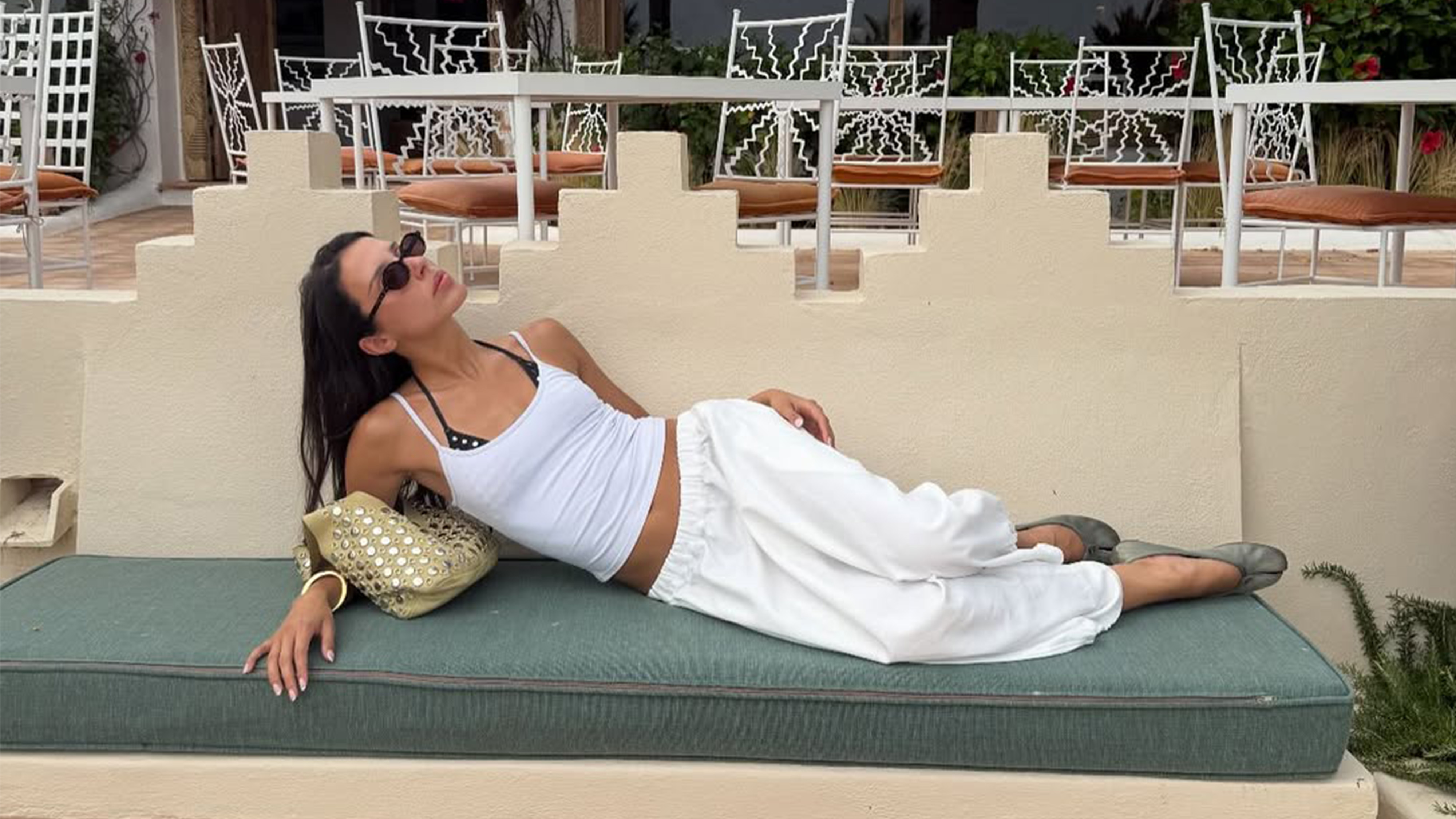 Woman lounging in an all white outfit.