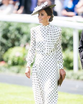 Kate Middleton wearing a white polka dot dress and hat