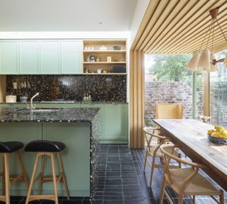 open plan kitchen and dining space with wood cladding