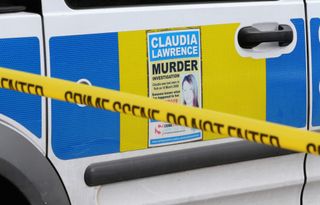 Missing poster of Claudia Lawrence against a police car