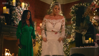 Sharon Watts wearing a bloodstained wedding dress while Denise Fox stands behind her holding a broken bottle