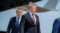 Defense Secretary Pete Hegseth (L) walks behind Army Secretary Dan Driscoll