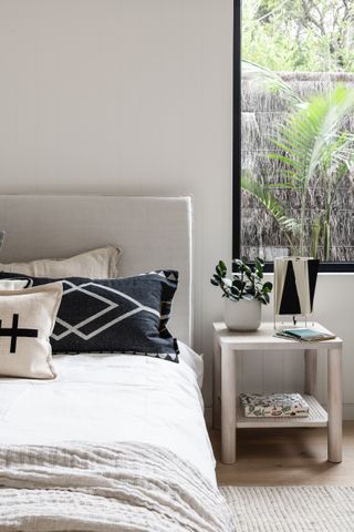 White bedroom with black throw cushions