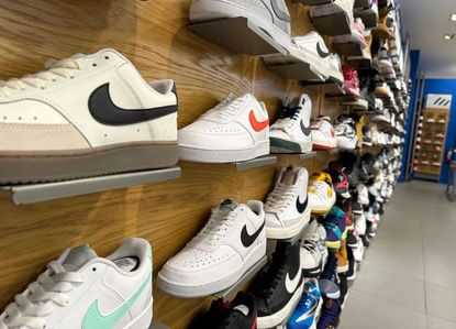 wall of Nike shoes in retail store