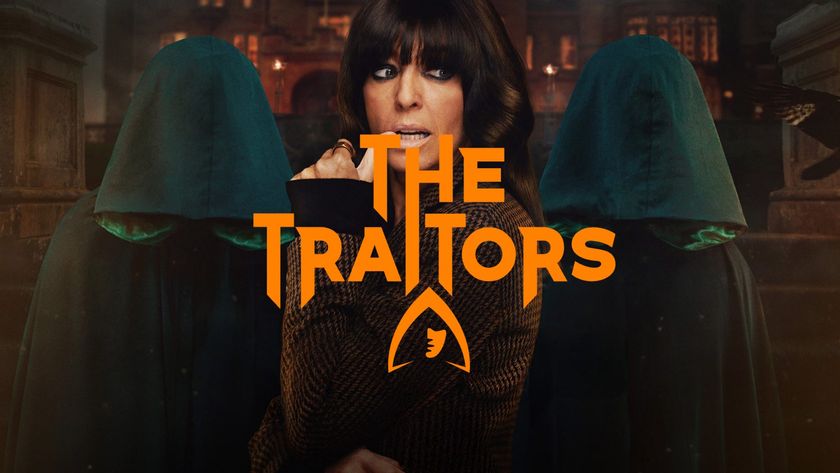 Claudia Winkleman stands pensively between two hooded figures in a promotional shot for the reality series The Traitors.