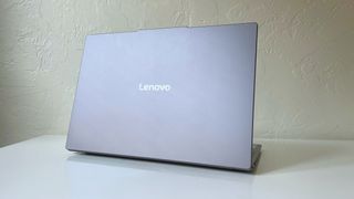 The Lenovo Yoga Slim 7i Aura edition seen from the back on a white table