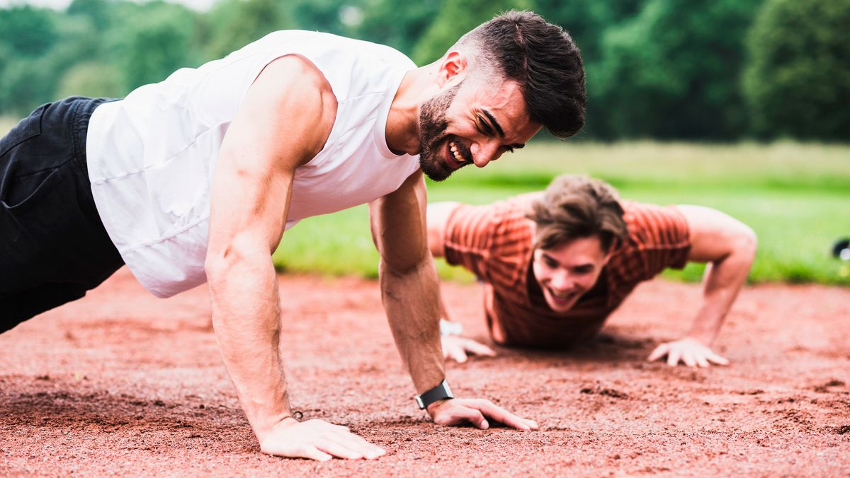 Two men performing push-ups outdoors