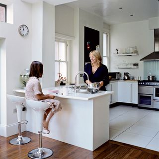women and child with kitchen and white cabinet