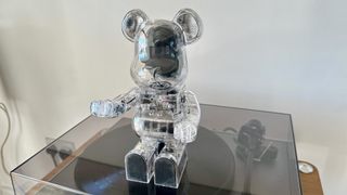 The Bearbrick Audio 400% Bluetooth speaker sat down on a record player