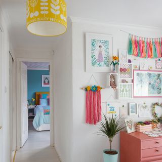 White girls bedroom with pink dresser and gallery wall