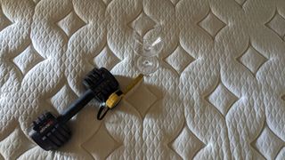 GhostBed Luxe mattress with weight and wine glass on it