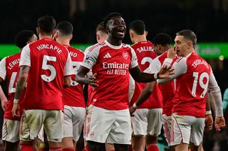Arsenal's English midfielder #07 Bukayo Saka (C) celebrates with teammates after his corner kick is diverted into his own net by Wolverhampton Wanderers' English goalkeeper #31 Sam Johnston during the English Premier League football match between Arsenal and Wolverhampton Wanderers at the Emirates Stadium in London on December 13, 2025. (Photo by Ben STANSALL / AFP) / RESTRICTED TO EDITORIAL USE. No use with unauthorized audio, video, data, fixture lists, club/league logos or 'live' services. Online in-match use limited to 120 images. An additional 40 images may be used in extra time. No video emulation. Social media in-match use limited to 120 images. An additional 40 images may be used in extra time. No use in betting publications, games or single club/league/player publications. /