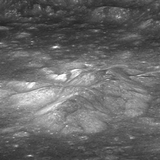 Scientists have detected evidence of water from the moon's interior in Bullialdus Crater. Pictured is the central peak of Bullialdus rising above the crater floor, with the crater wall in the background.