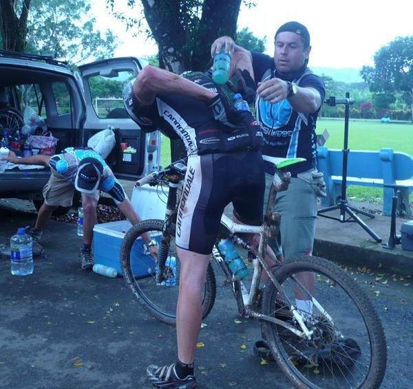 A Team Cannondale rider gets helps stuffing his pocket at checkpoint #4.