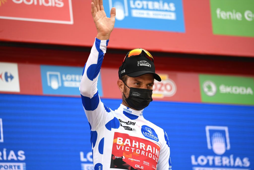 RINCON DE LA VICTORIA SPAIN AUGUST 24 Damiano Caruso of Italy and Team Bahrain Victorious celebrates winning the Polka Dot Mountain Jersey on the podium ceremony after the 76th Tour of Spain 2021 Stage 10 a 189km stage from Roquetas de Mar to Rincn de la Victoria lavuelta LaVuelta21 on August 24 2021 in Rincon De La Victoria Spain Photo by Tim de WaeleGetty Images