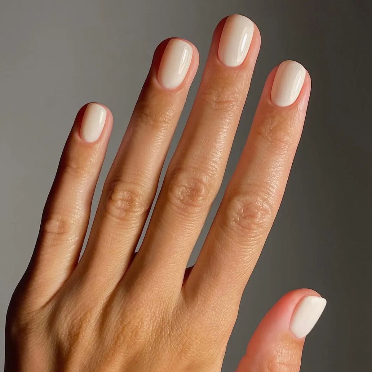 Off-white nail polish.