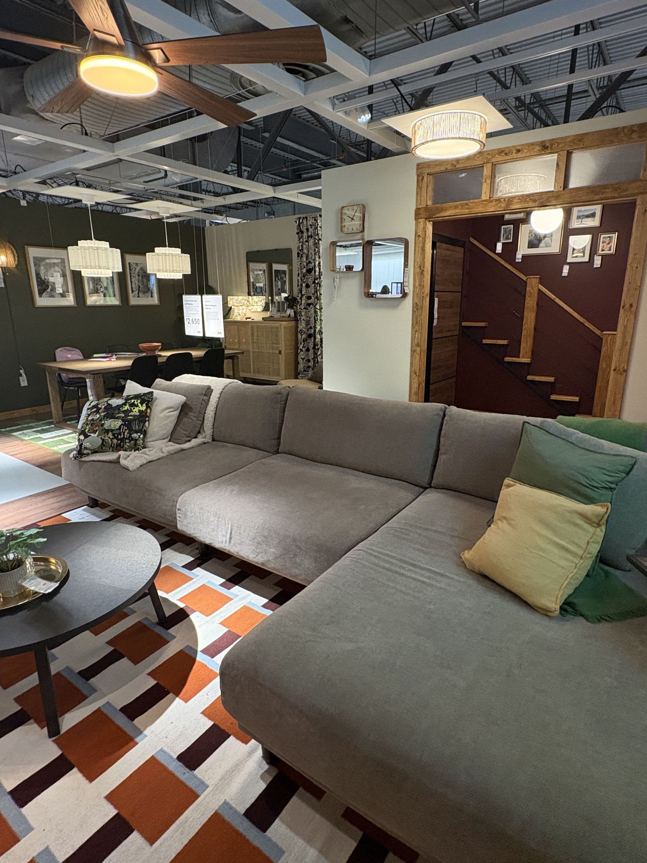a large brown sectional sofa in an IKEA showroom.