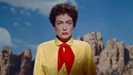 Joan Crawford wearing a bright yellow shirt in Johnny Guitar