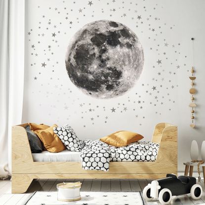 yellow couch with moon and stars on wall