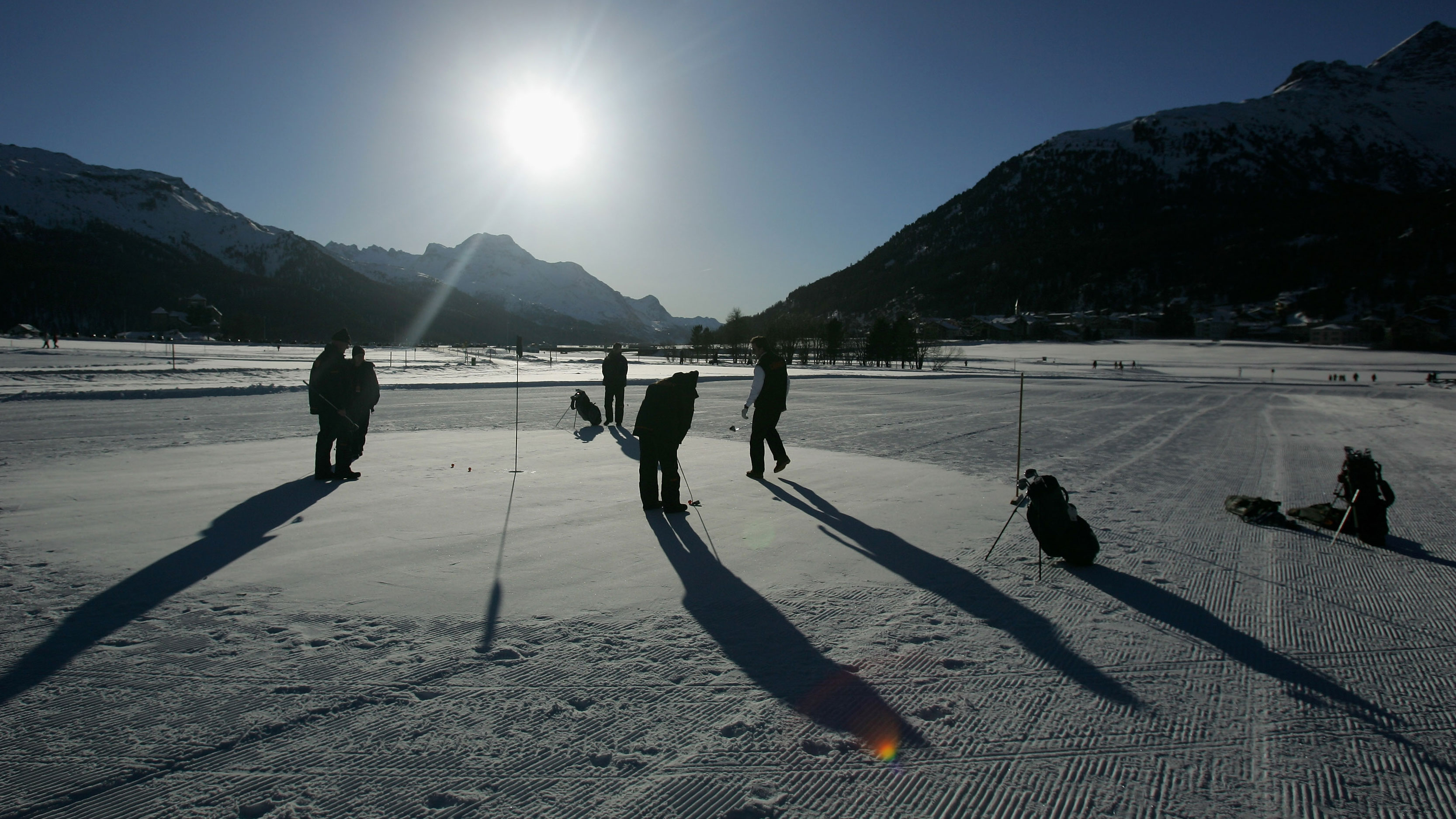 golfers playing in the snow