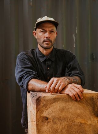 Ido Yoshimoto's workshop in Inverness, California, photographed under a blue sky and with wooden elements from his production