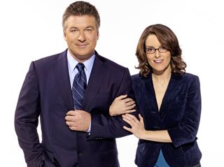 alec baldwin as jack donaghy and tina fey as liz lemon linking arms in a promo shot for 30 Rock