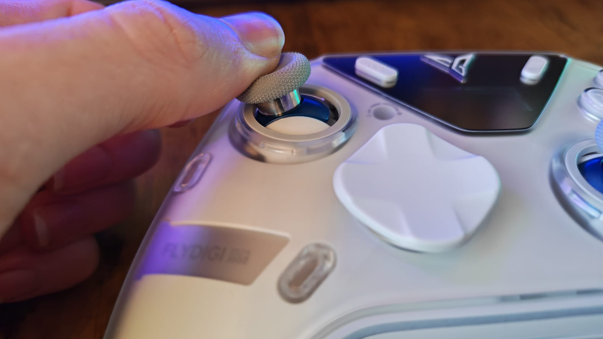 A reviewer showcasing the thumbstick module axes on the Flydigi Apex 5