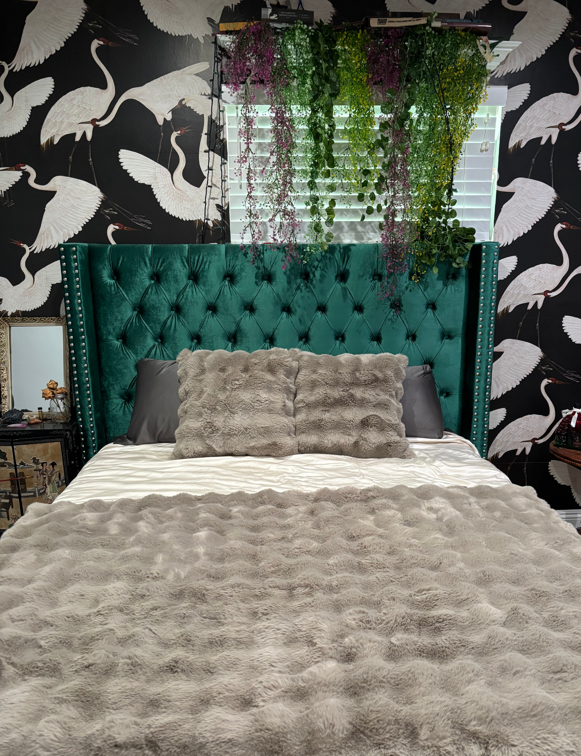 Cozy Earth Bubble Cuddle Pillow pictured in a bedroom featuring crane wallpaper and an emerald tufted headboard