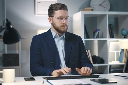 Man on laptop trading after market hours