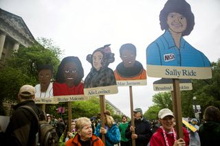 Science supporters hold up cardboard puppets honoring scientists and astronauts during the March for Science in Washington, D.C. on April 22, 2017.
