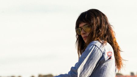 Adria Arjona wearing sunglasses in Onslaught.